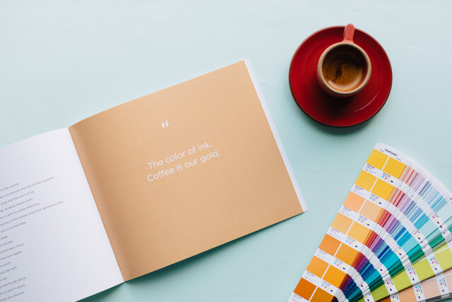 brand book with "coffee is our gold" quote