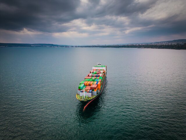 Aerial view of a loaded container ship at sea
