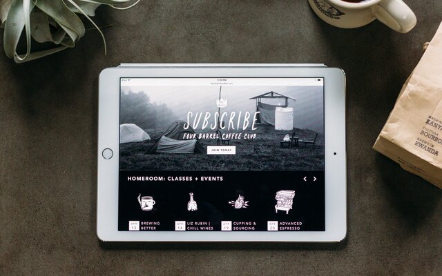 Home page of the Four Barrel Coffee responsive website shown on an iPad.