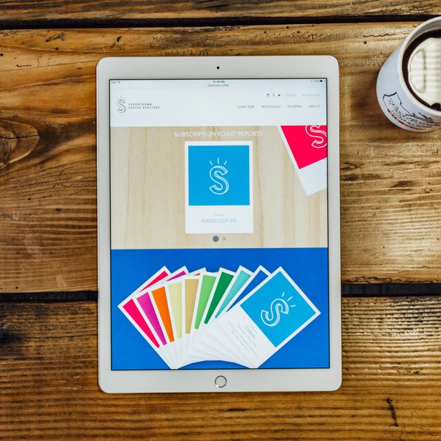 The responsive Supercrown Coffee website shown on an iPad.