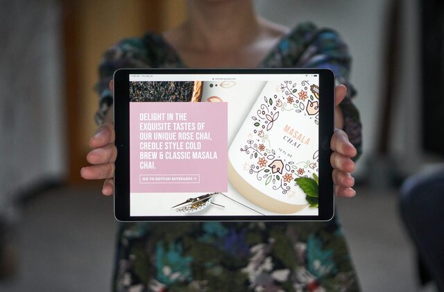hands holding site on iPad