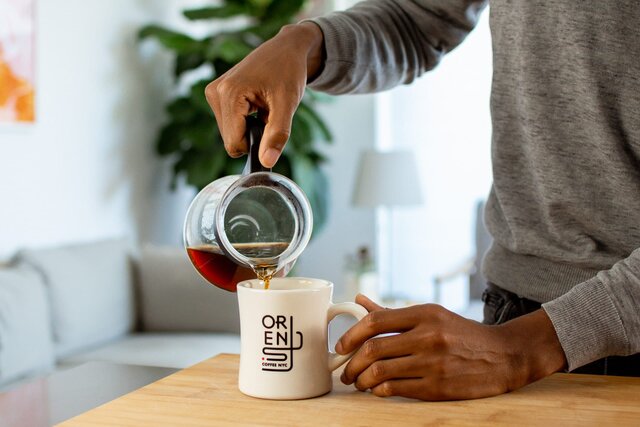 pouring a cup of orens coffee