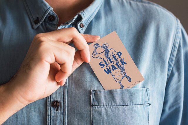 Person tucking business card into their pocket