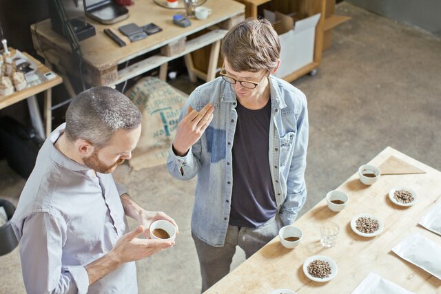 Coffee business owner and customer discussing coffee