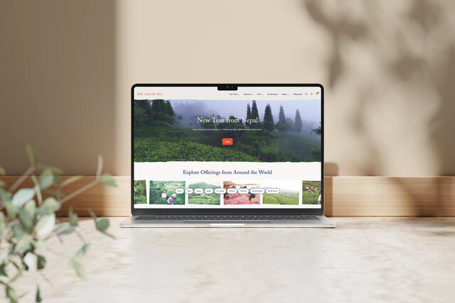 Tao of Tea website home page on a laptop, featuring a large image of tea field and smaller images inviting one to explore tea from around the world